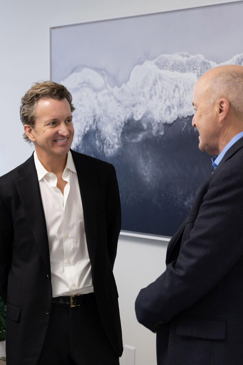 A group photo captures several attendees standing together and smiling at an indoor gathering.